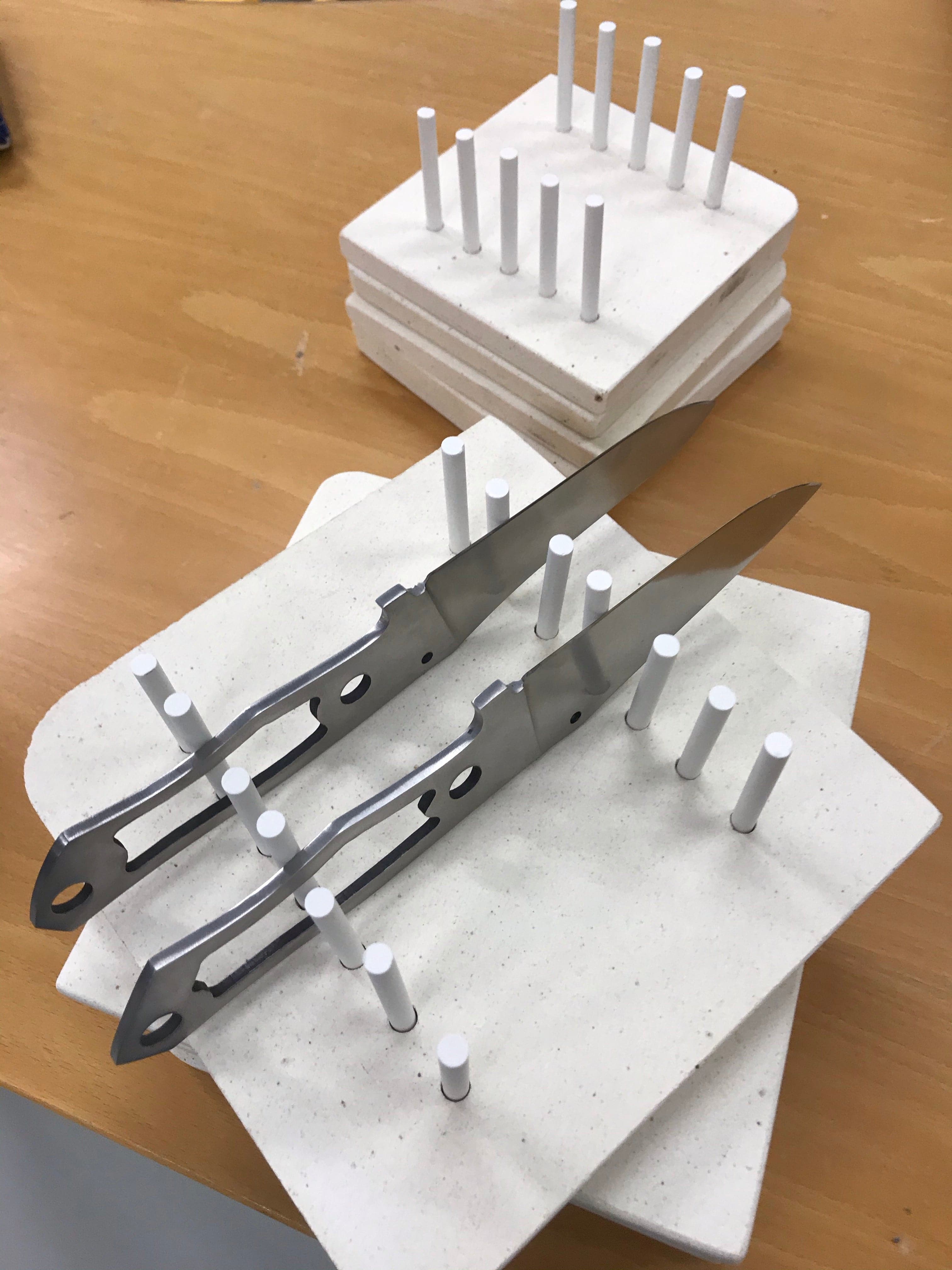 Knife blade holder for curing oven
